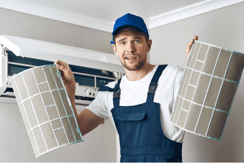 aircon technician holding aircon filters
