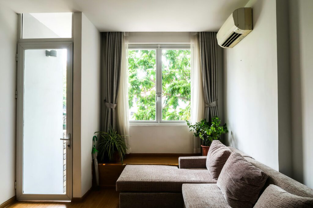 https://www.pexels.com/photo/a-cozy-couch-near-the-window-and-plants-6914713/