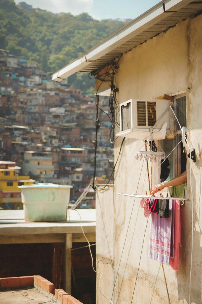 https://www.pexels.com/photo/person-hanging-clothes-on-window-9296088/