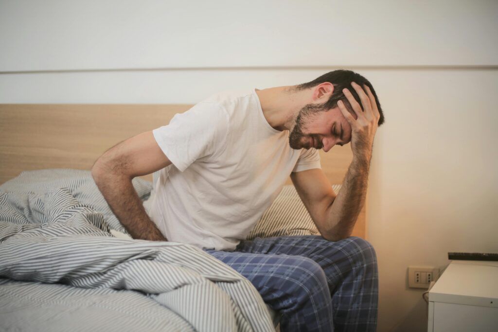 https://www.pexels.com/photo/young-man-in-sleepwear-suffering-from-headache-in-morning-3771115/