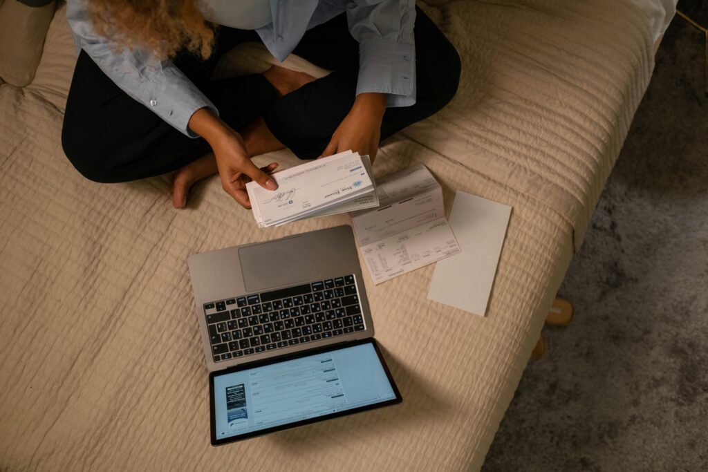 https://www.pexels.com/photo/overhead-shot-of-a-woman-holding-a-cheque-6862458/